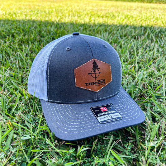 THICKET Logo Leather Patch Trucker Hat | Charcoal + White