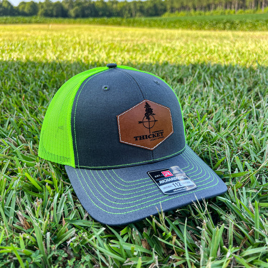 THICKET Logo Leather Patch Trucker Hat | Charcoal + Safety Green